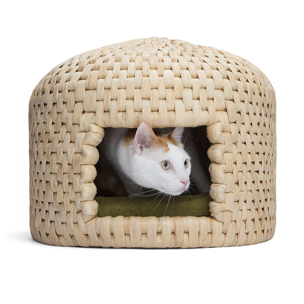 Cat peeking out from eco friendly handwoven neko chigura straw cat bed house